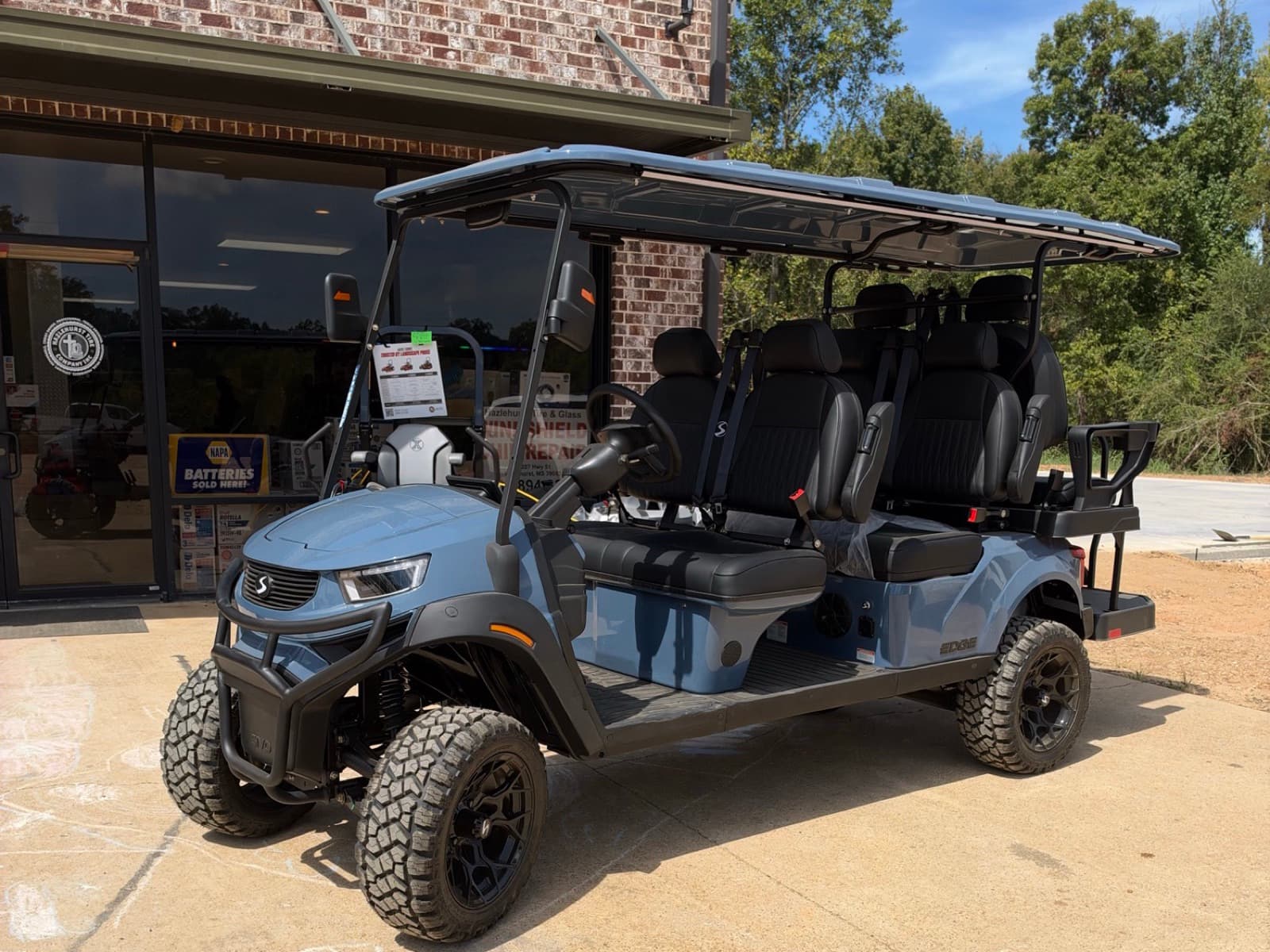 Blue SIVO Edge 6-passenger golf cart with a rear seat at Hazlehurst Tire Company