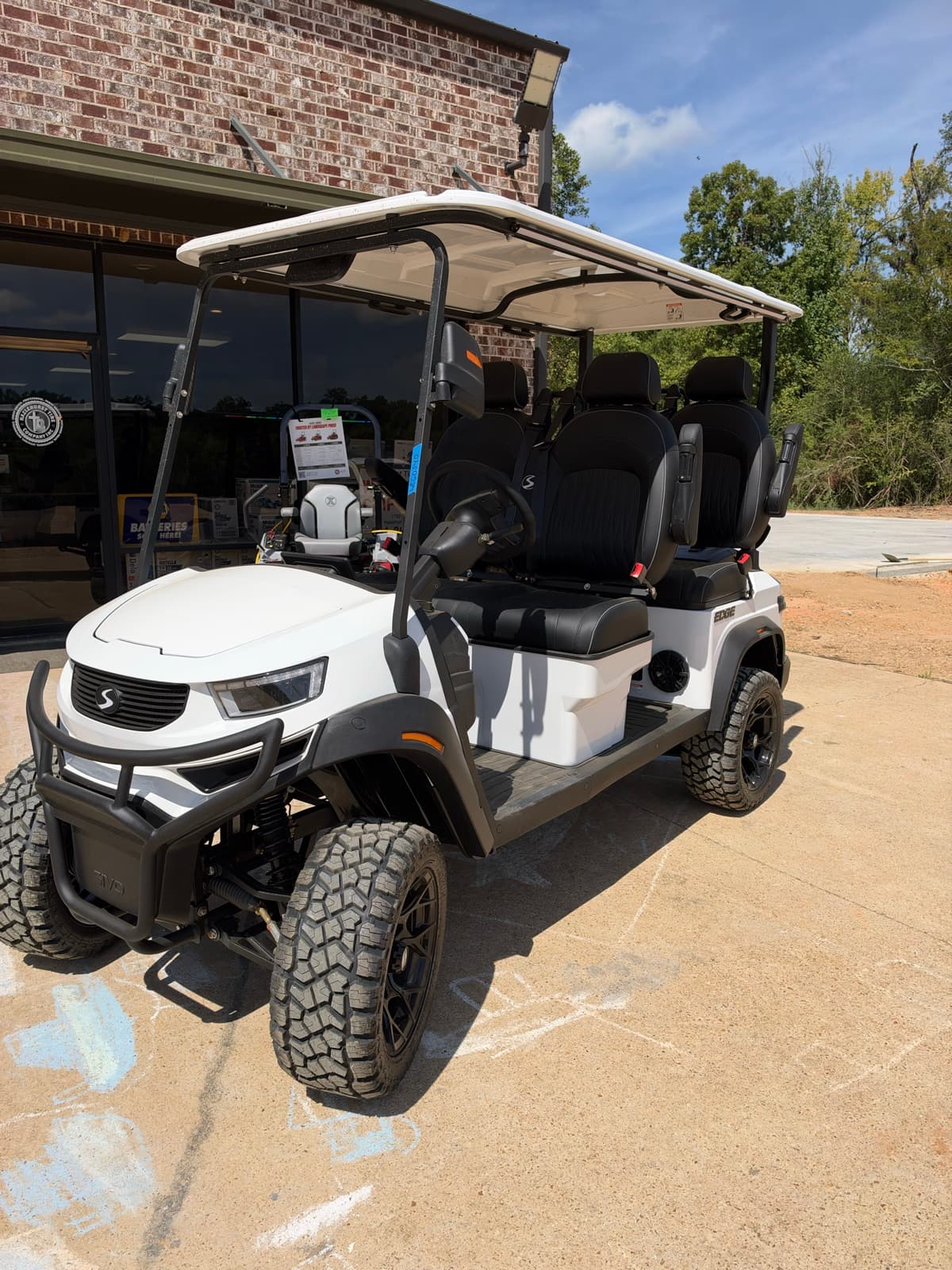 White lifted SIVO Edge 4-passenger golf cart at Hazlehurst Tire Company