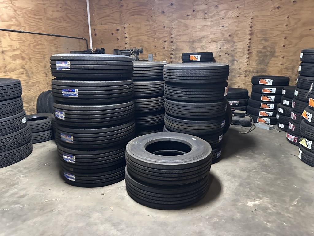 Tall stacks of new tires stored in the warehouse at Hazlehurst Tire Company