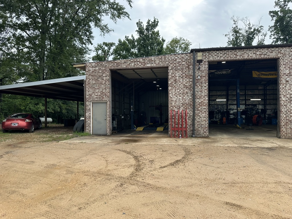 Open service bays at Hazlehurst Tire Company with Goodyear and Rovelo banners visible inside